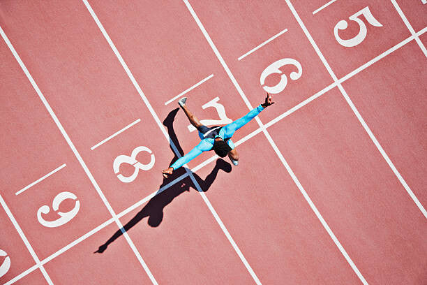 Leinwand Poster, Bilder Runner crossing finishing line on track, Paul Bradbury, 90 × 60 cm